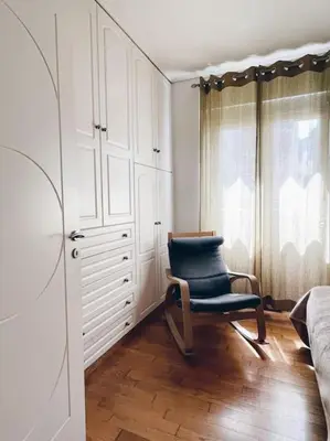 a bedroom with a blue chair next to a bed at CS Central Apartment in Athens