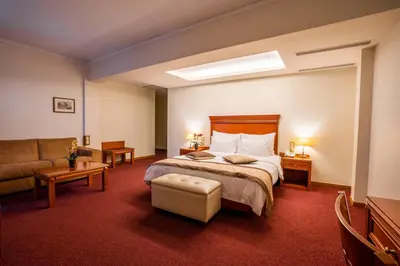 a hotel room with a bed and a couch at Ilissos in Athens