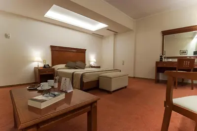 a hotel room with a bed and a table at Ilissos in Athens