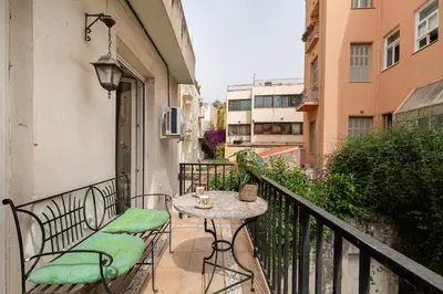 a balcony with a table and chairs on a balcony at Athenian Gate to Plaka by Athenian Homes in Athens