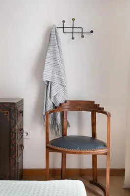 a wooden chair with a towel hanging on a wall at Athenian Gate to Plaka by Athenian Homes in Athens