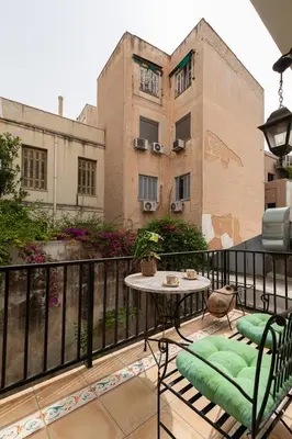 a balcony with a table and chairs and a building at Athenian Gate to Plaka by Athenian Homes in Athens