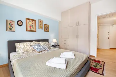 a bedroom with a bed with towels on it at Athenian Gate to Plaka by Athenian Homes in Athens