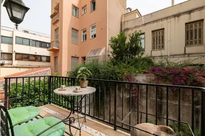 a patio with a table and chairs on a balcony at Athenian Gate to Plaka by Athenian Homes in Athens