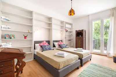two beds in a room with white shelves at Athenian Gate to Plaka by Athenian Homes in Athens