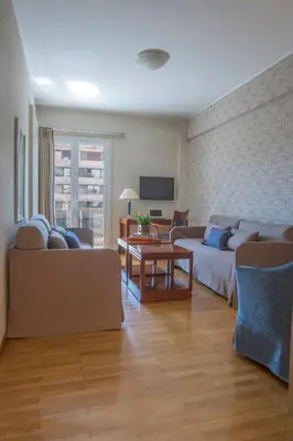 a living room with a couch and a table at Delice Hotel - Family Apartments in Athens