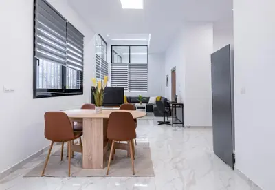a dining room with a table and chairs at LIV - Modern Spacious Apartment in Gazi in Athens