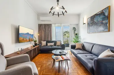 a living room with a couch and a table at Two-Bedroom Apartment in Pagrati in Athens