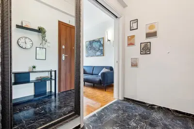 a mirror in a hallway leading to a living room at Two-Bedroom Apartment in Pagrati in Athens