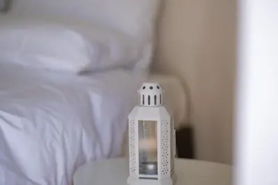 a plastic bottle sitting on a table next to a bed at \u8212\u9002\u6f02\u4eae\u7684\u4f11\u95f2\u516c\u5bd3 in Athens