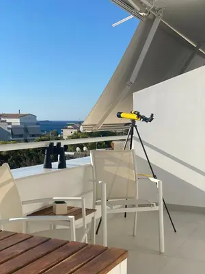 a camera on a roof with chairs and a table at Aphrodite Suite byArtistUnknown in Vari