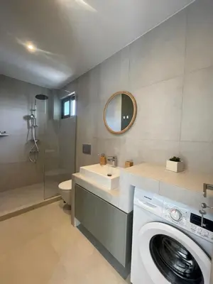 a bathroom with a washing machine and a washer at Aphrodite Suite byArtistUnknown in Vari