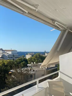 a balcony with a view of the city at Aphrodite Suite byArtistUnknown in Vari