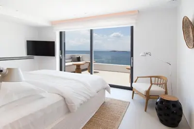 a bedroom with a bed and a view of the ocean at Greece Dream Holidays Villas 1 in Athens