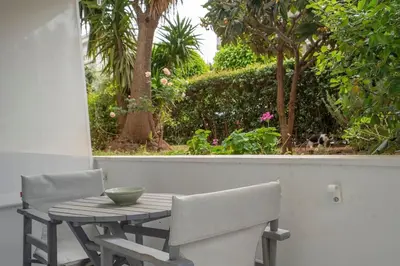 a table with two chairs and a bowl on it at Bright & Breezy Glyfada Studio in Athens
