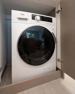 a washing machine in a wall in a room at Bright & Breezy Glyfada Studio in Athens