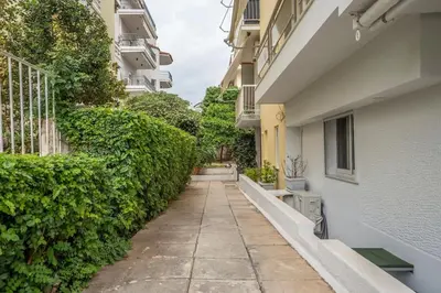 an alleyway between two buildings with plants at Bright & Breezy Glyfada Studio in Athens
