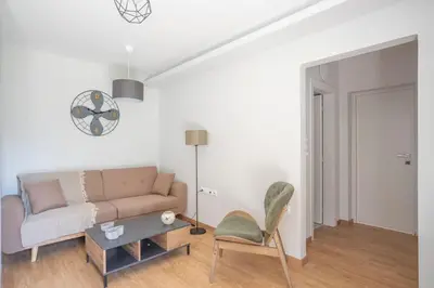 a living room with a couch and a chair at Tranquil Voula Getaway, A Calm Retreat in Voula in Athens