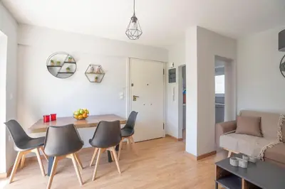 a living room with a table and chairs and a couch at Tranquil Voula Getaway, A Calm Retreat in Voula in Athens