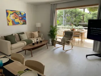 a living room with a couch and a table at Vouliagmeni Seaside Luxury Home in Athens