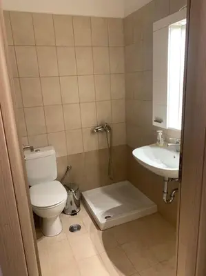 a bathroom with a toilet and a sink at Vasiliki’s Guesthouse II in Athens