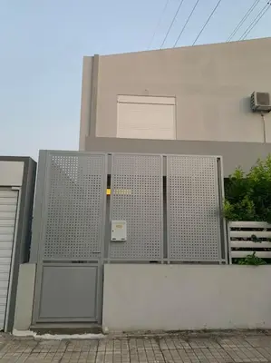 a building with its doors open on the side of it at Vasiliki’s Guesthouse II in Athens