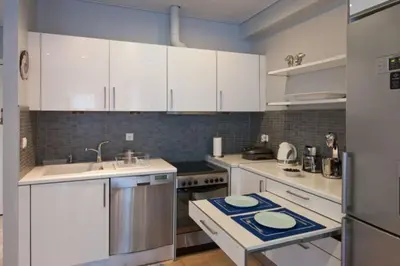a kitchen with white cabinets and a sink at Acropolis Luxury Apartment with Balcony in Athens