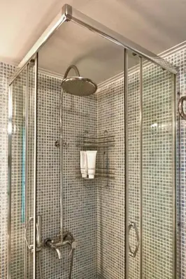 a shower with a glass door in a bathroom at Acropolis Luxury Apartment with Balcony in Athens