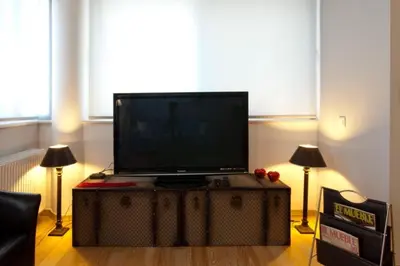a flat screen tv sitting on top of a table at Acropolis Luxury Apartment with Balcony in Athens