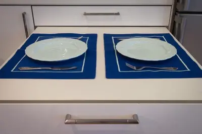 two plates and silverware sitting on a stove top at Acropolis Luxury Apartment with Balcony in Athens