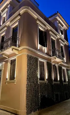 a large white building with lights on it at Epitome Suites in Athens