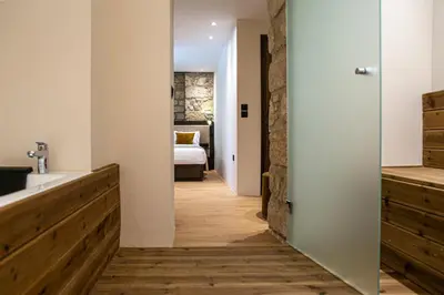 a bathroom with a sink and a bed in a room at Epitome Suites in Athens