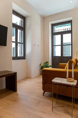 a living room with a couch and a table at Epitome Suites in Athens