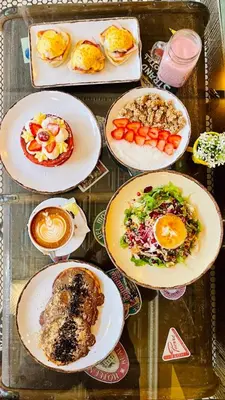 a bunch of plates of food on a glass table at Epitome Suites in Athens