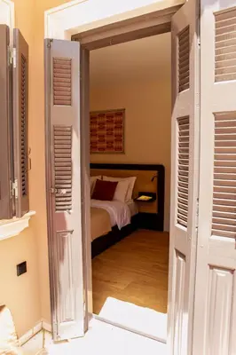 an open door to a bedroom with a bed at Epitome Suites in Athens