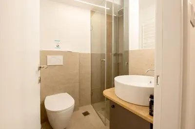 a bathroom with a toilet and a sink at Plaka Apartments - Acropolis View in Athens