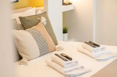 a bed with three folded towels on it at Plaka Apartments - Acropolis View in Athens