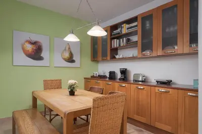 a kitchen with a wooden table and a dining room at Lussuosa Villa Glyfada in Athens