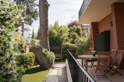a balcony with a table and chairs and a tree at Lussuosa Villa Glyfada in Athens