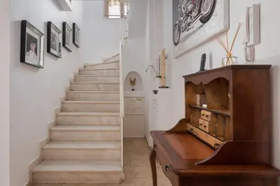 a staircase with a piano and a wooden table in a room at Lussuosa Villa Glyfada in Athens