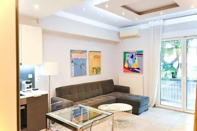 a living room with a couch and a table at Apartment in Kolonaki in Athens