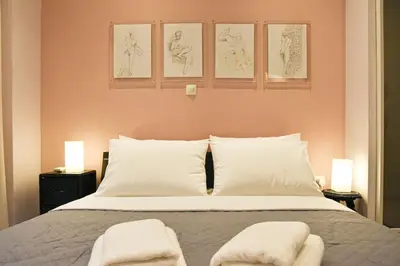 a bedroom with a bed with two towels on it at Apartment in Kolonaki in Athens