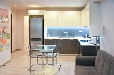 a kitchen with a glass table and a couch at Apartment in Kolonaki in Athens