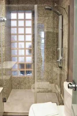 a bathroom with a glass shower with a toilet at Apartment in Kolonaki in Athens