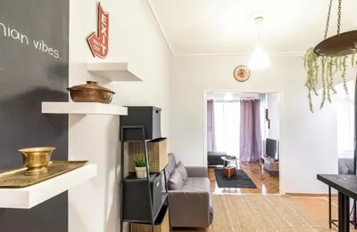 a living room with a couch and a table at Cosy Central Apartment in Plaka in Athens