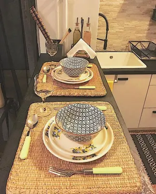 a kitchen with two plates and bowls on a table at Cosy Central Apartment in Plaka in Athens