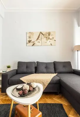 a living room with a couch and a table at Cosy Central Apartment in Plaka in Athens