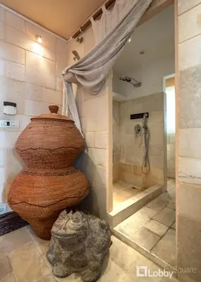 a bathroom with a shower and a large tub at OBSRV Penthouse by LobbySquare in Athens