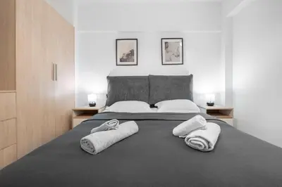 a bedroom with a large bed with towels on it at Oculus Gelonos 1 BD City Apartment by Live&Travel in Athens