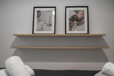 two framed photographs on a fireplace mantel at Oculus Gelonos 1 BD City Apartment by Live&Travel in Athens